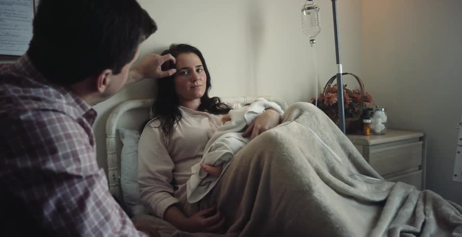 A man touches a woman who just gave birth