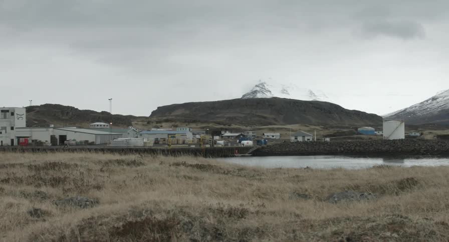 Factory sitting with several buildings around it in a desolate area