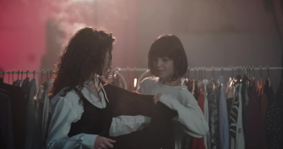 Two women trying on clothes