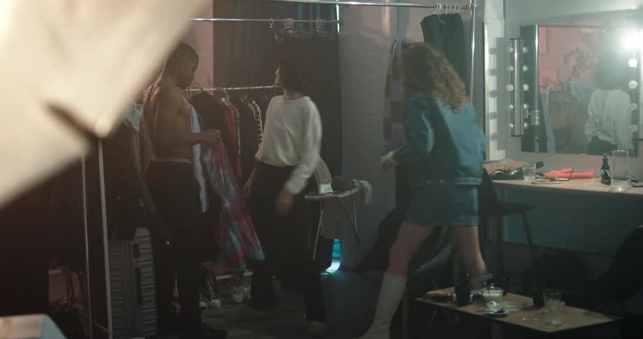 Group of models changing clothes in the backstage of a photo shoot