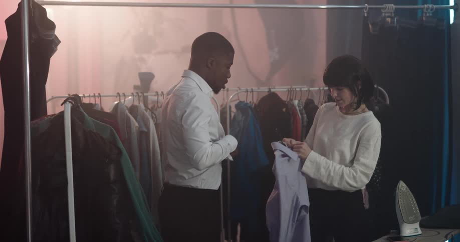 Two people are in a dressing room and talking
