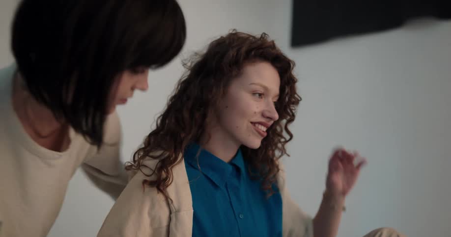 A stylist fishes a models hair and jacket during a shoot