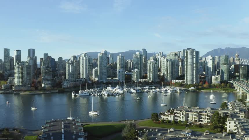 The boats are docked in the harbor near Vancouver