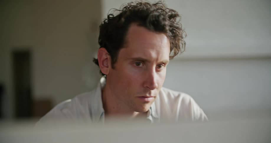 A man is looking at a screen indoors