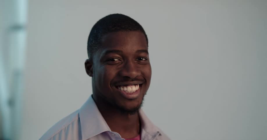 A model turns his head and smiles