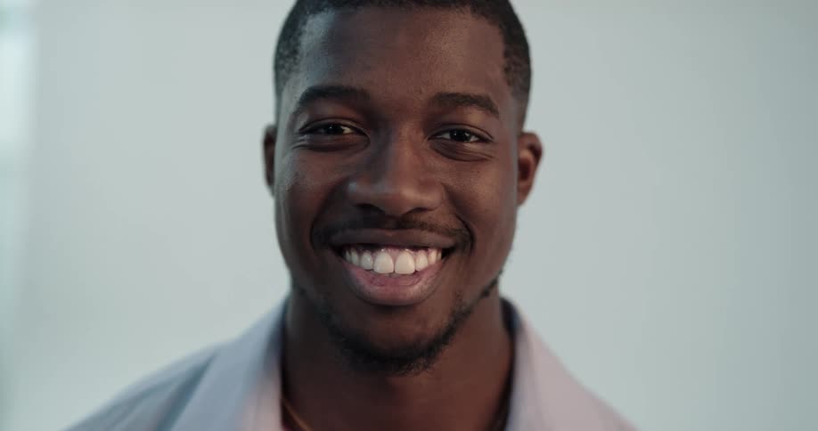 Young man turns to look at the camera and smiles