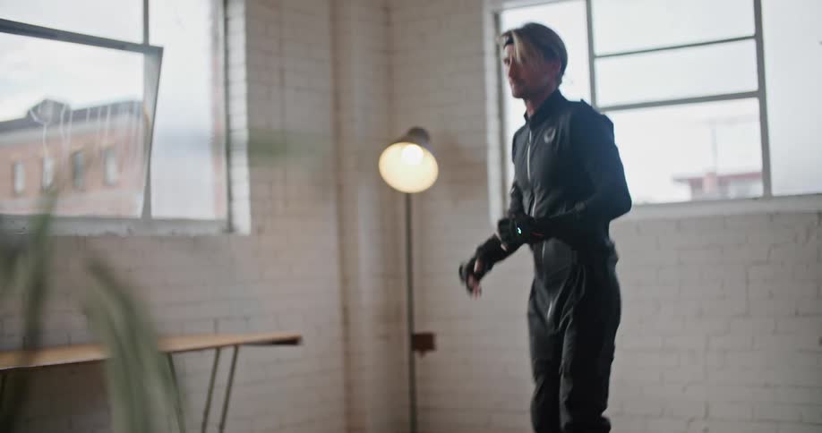 A man wearing virtual reality devices is practicing martial arts movements
