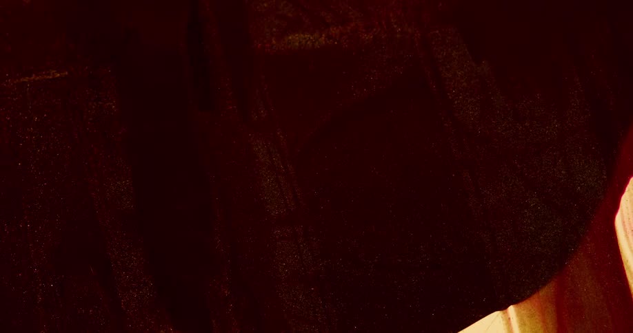 Dark red liquid flowing over a surface