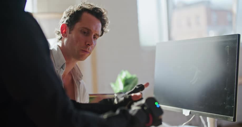 A man uses software to operate gloves