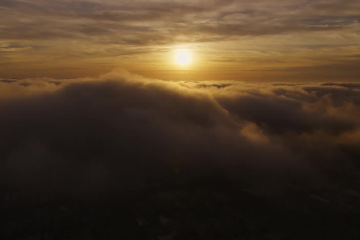 An aerial view flying above clouds