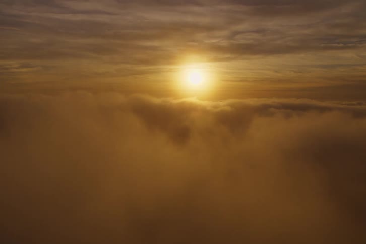 Above the clouds the sun is rising