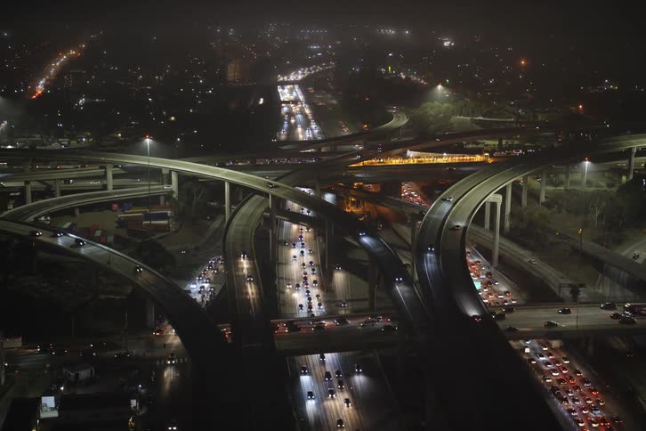 Arial view of heavy traffic on a highway intersection in the city at night