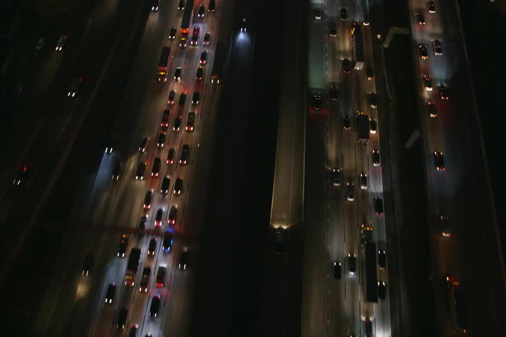 Traffic flows over parallel controlled access highways sitting at different heights and passing through city