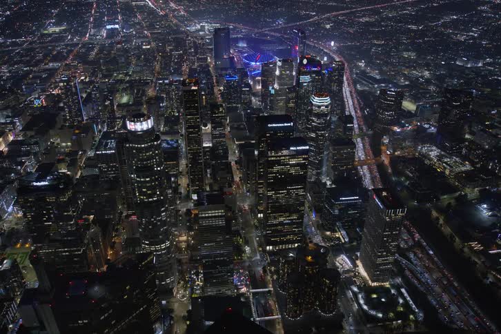 Aerial view of illuminated high rise buildings and skyscrapers in the city at night