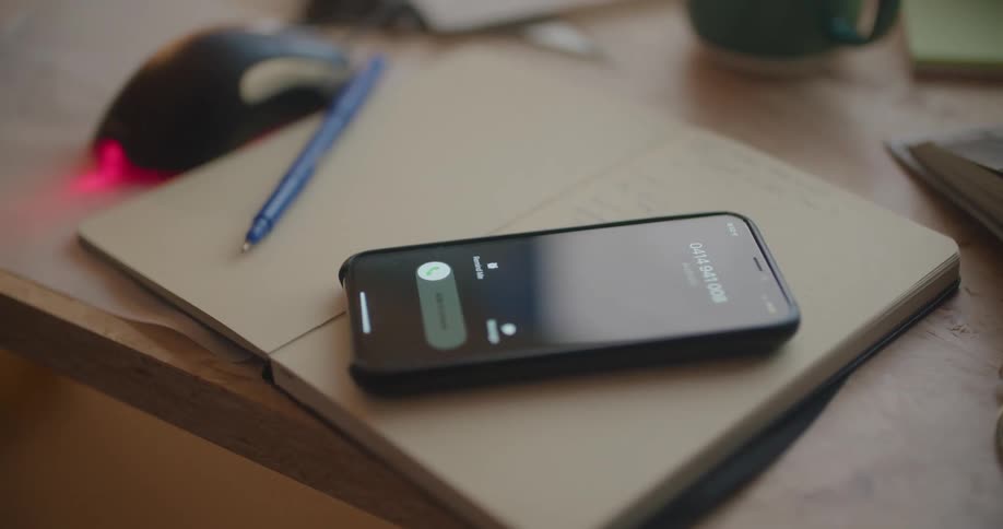 Female hand grabbing cell phone to answer incoming call