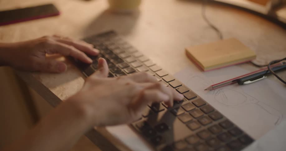 Close of female hands typing on a computer keyboard