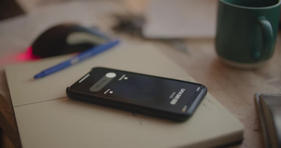 Female hand grabbing cell phone to answer incoming call