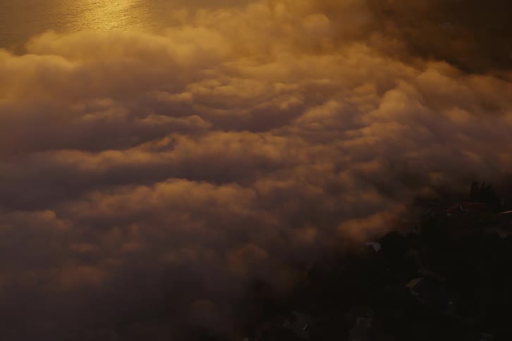 The golden light of the sun shines on the clouds