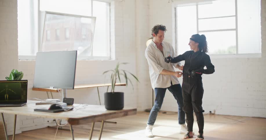 A man adjusts the vr outfit on the woman