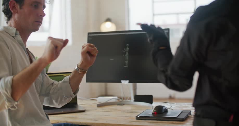 A man is testing vr gloves with a woman
