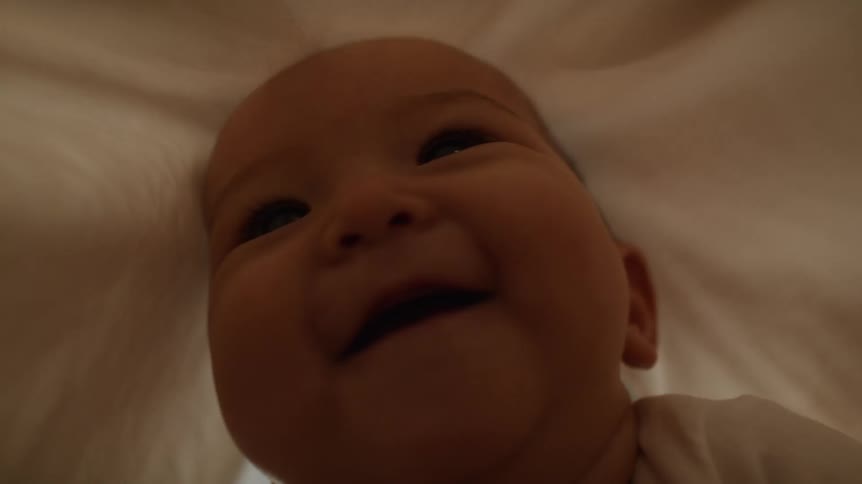 A sheet is put on a babys head