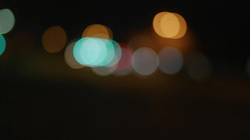 The vehicle lights move at night