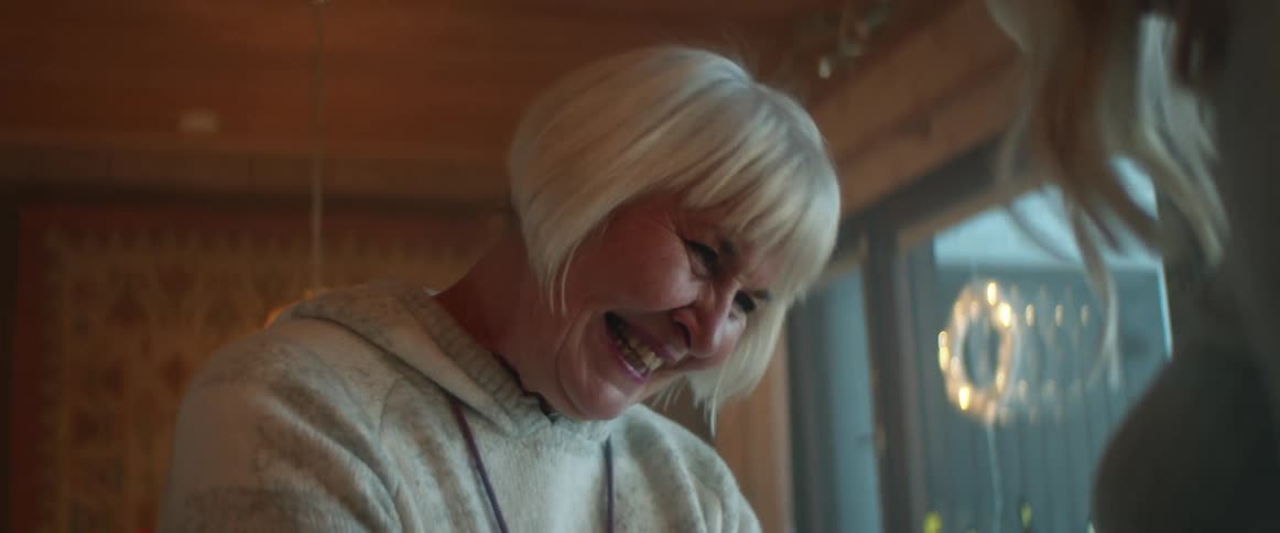 Two women are talking together and laughing