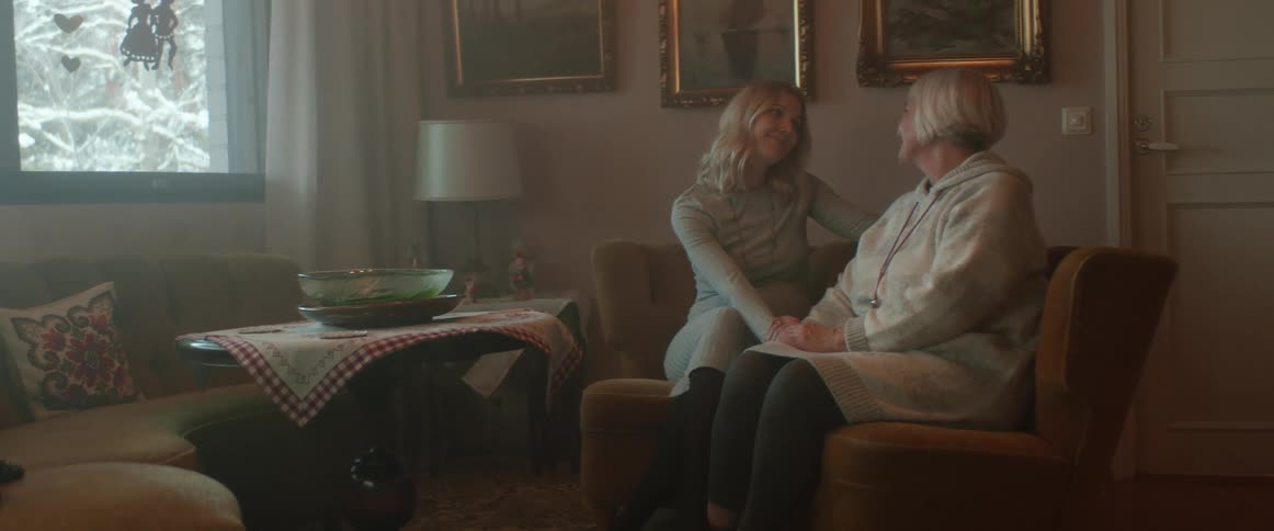An elderly mother talking with her daughter