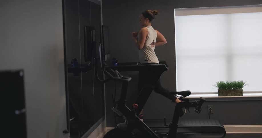 Woman jogging on treadmill at her home gym