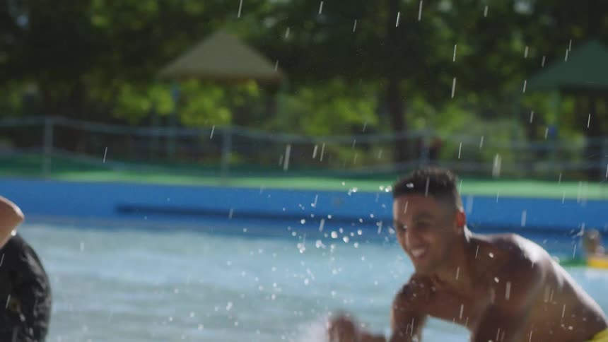 Young teenage friends splash and play in the water