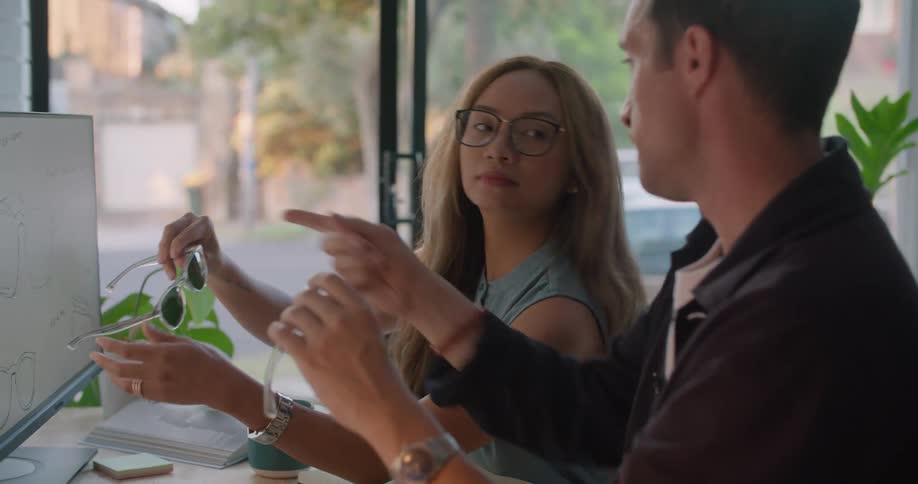 Two people are collaborating on designing glasses
