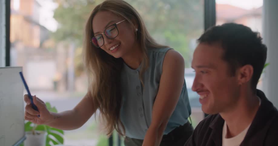 Male and female coworkers work on computers in the office