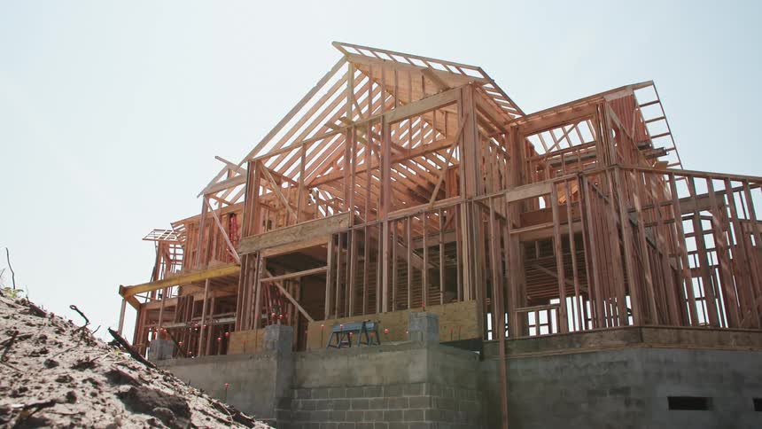 New construction residential framed home above concrete foundation