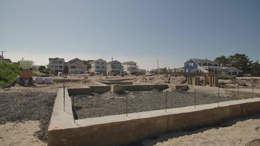 Gravel fills stone concrete perimeter of area under construction in neighborhood