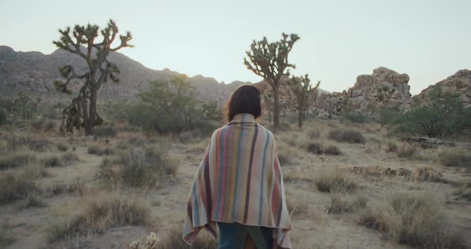 A woman walking out in a desert