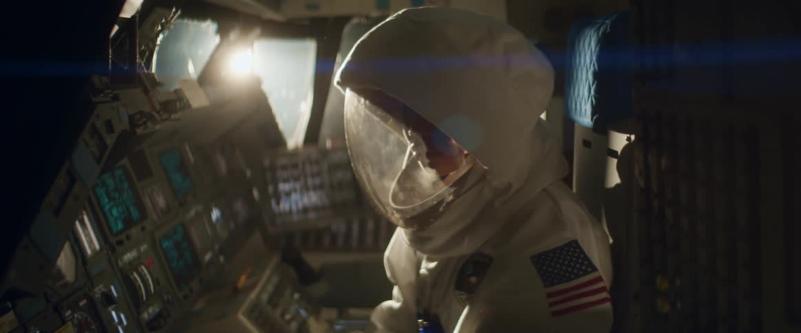 An astronaut fiddles with the control panel in an aircraft
