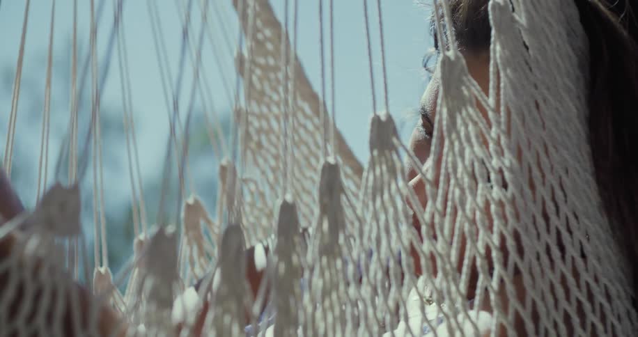 A woman is sleeping in the hammock
