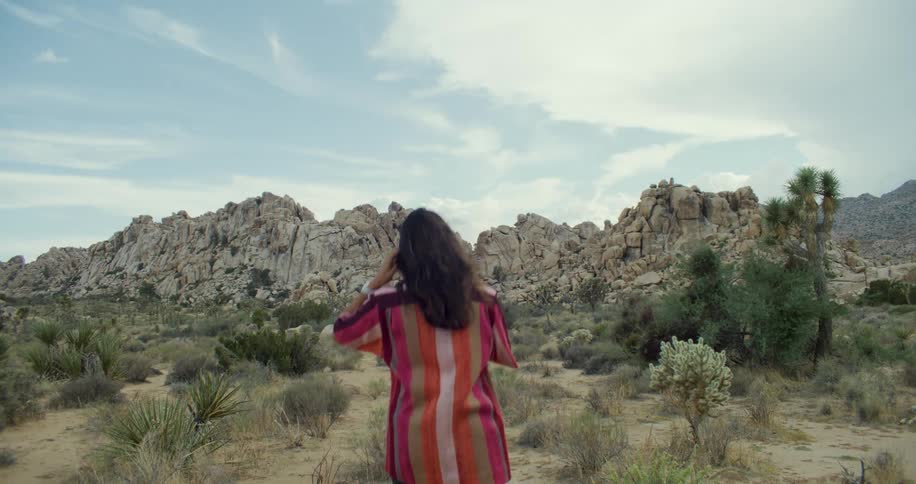 A woman walks out into the badlands