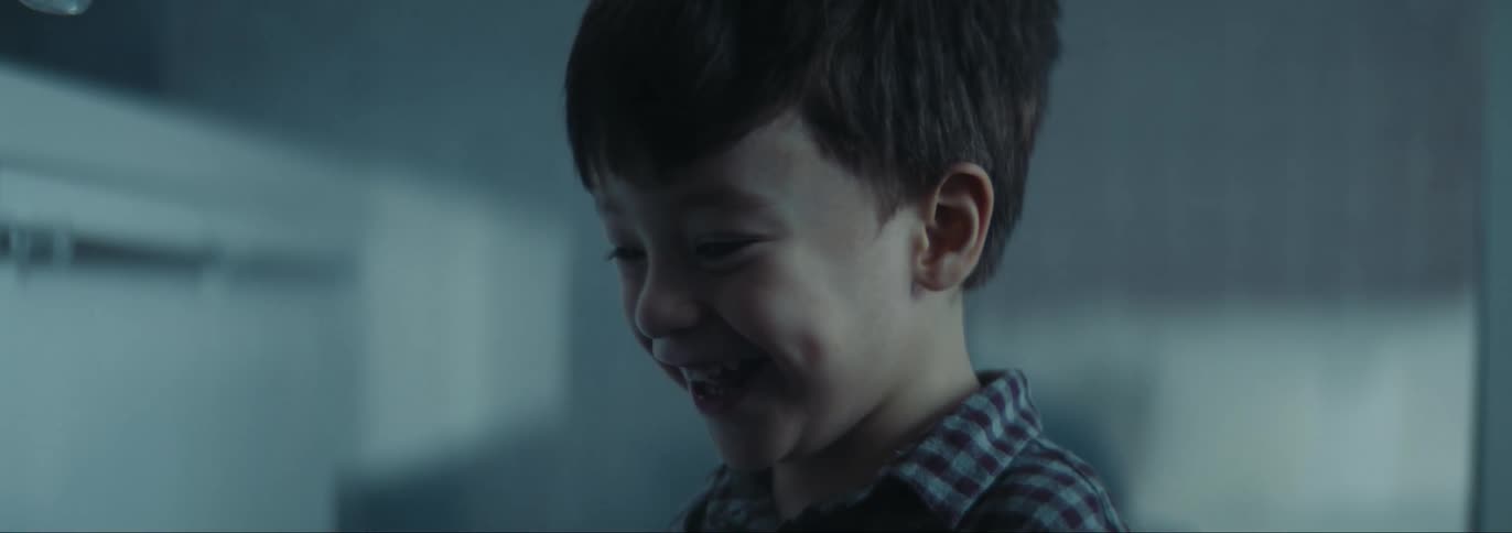 Boy smiles and talks as he looks around