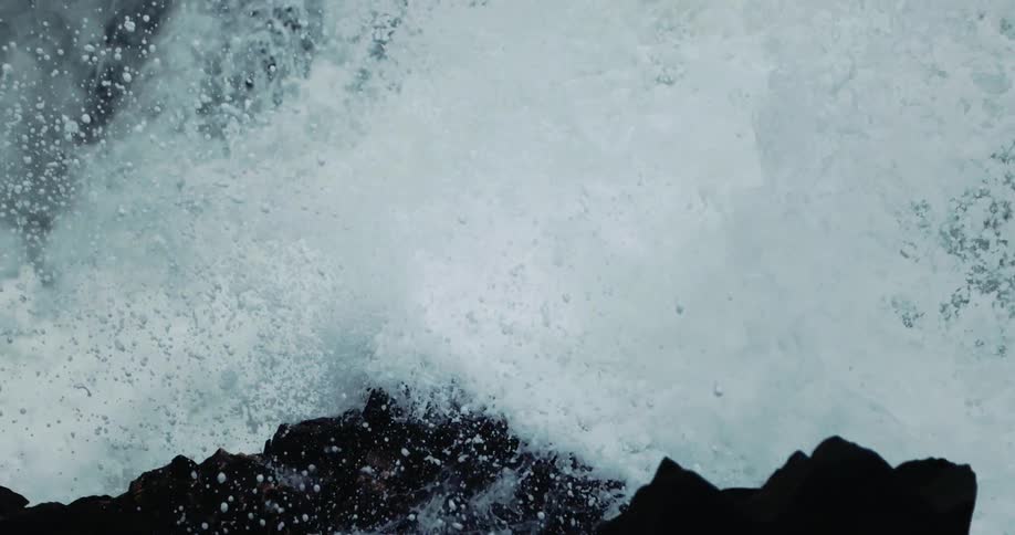 Waves crashing in to rocks on the shore