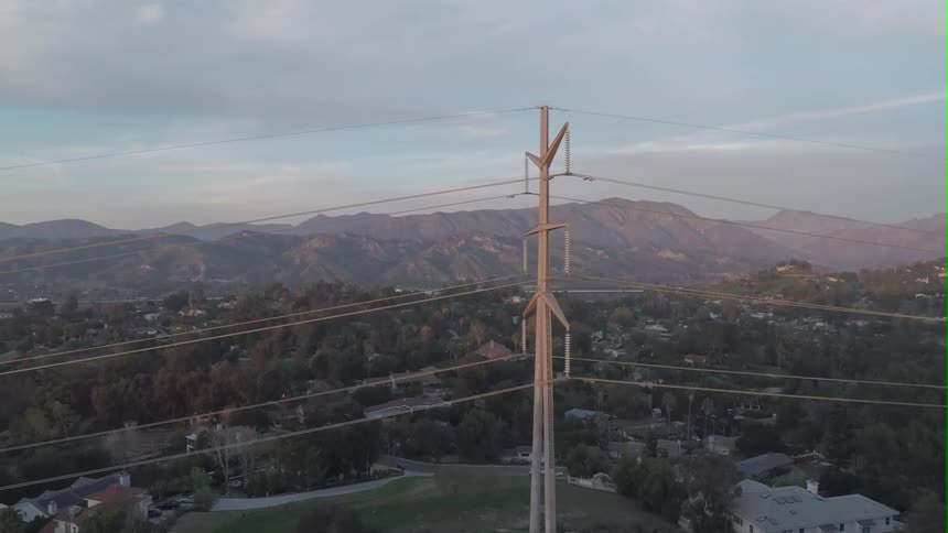 A power line stands over a town