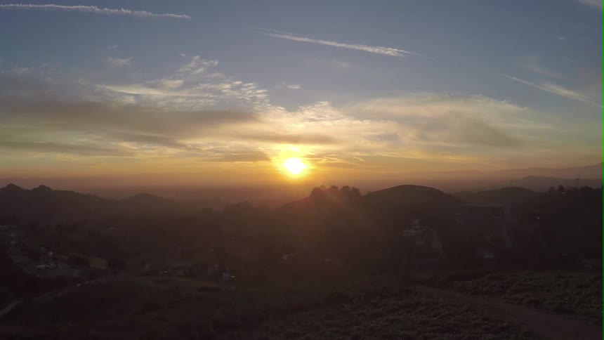 Sun setting over mountains