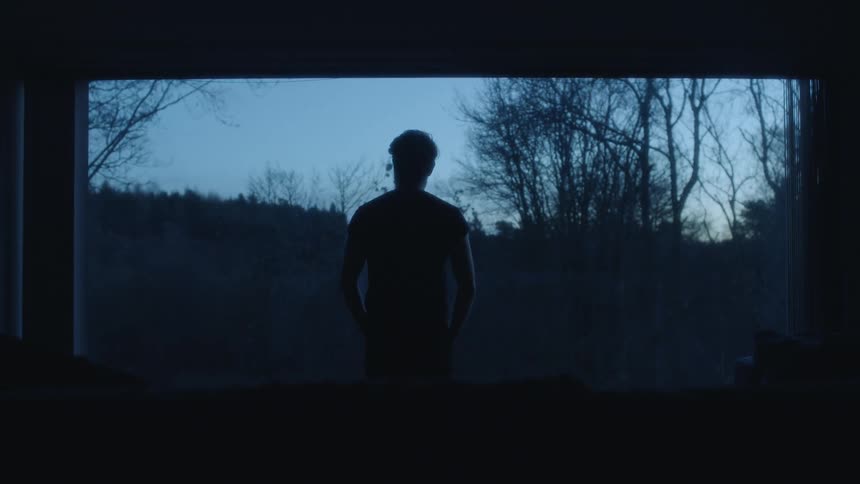A man staring out of a window