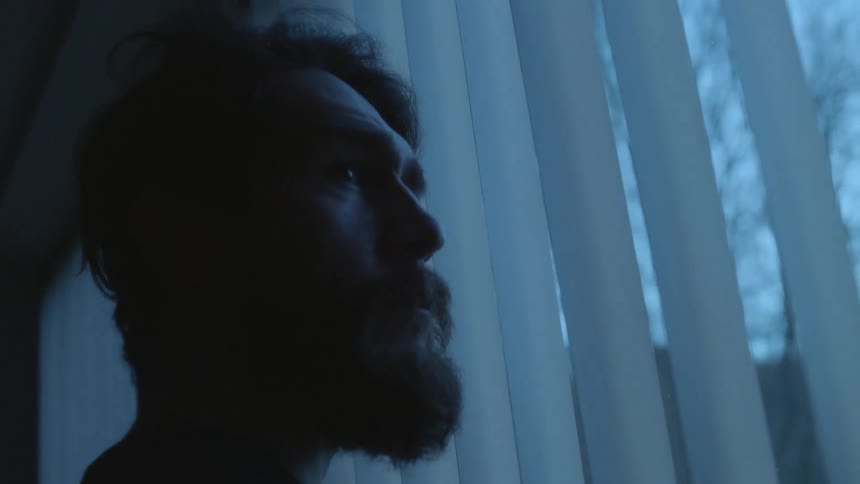 A man looking out a window
