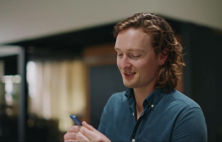 A man looking at something and smiling