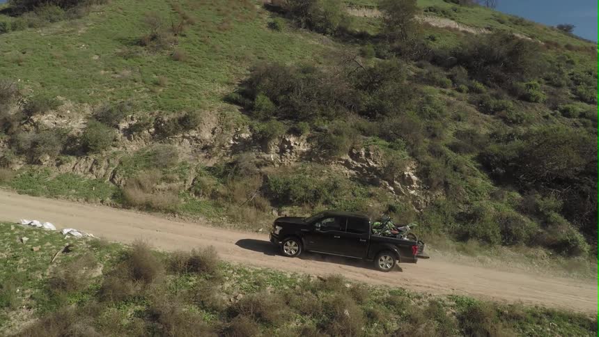 A truck driving down a dirt road