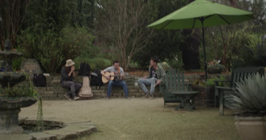 Three performers playing their instruments