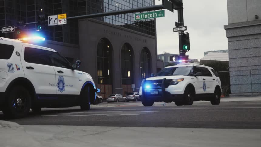 Police vehicles are parked blocking the street