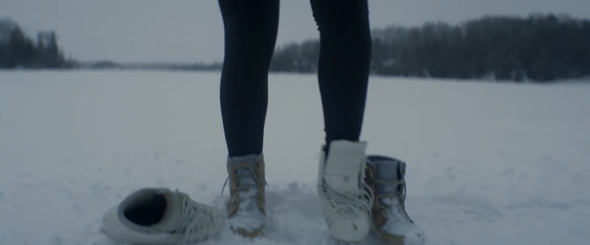 A view of a woman putting on ice skates