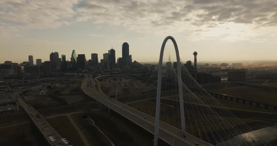 Aerial view of the margaret hunt hill bridge near the dallas skyline at sunset